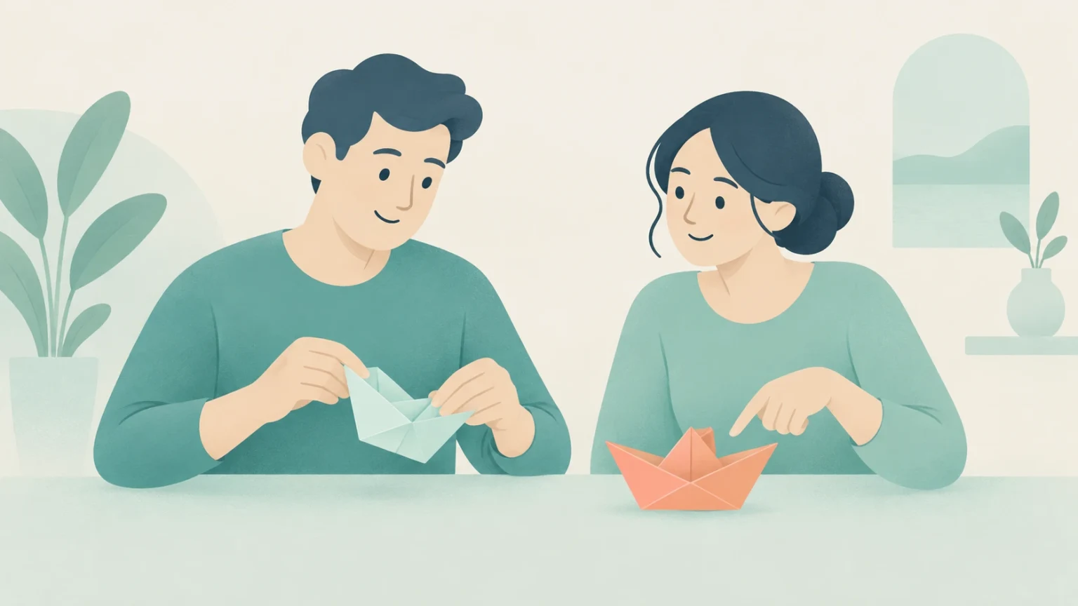 A man folds a paper boat while a woman points to a completed origami boat on the table.