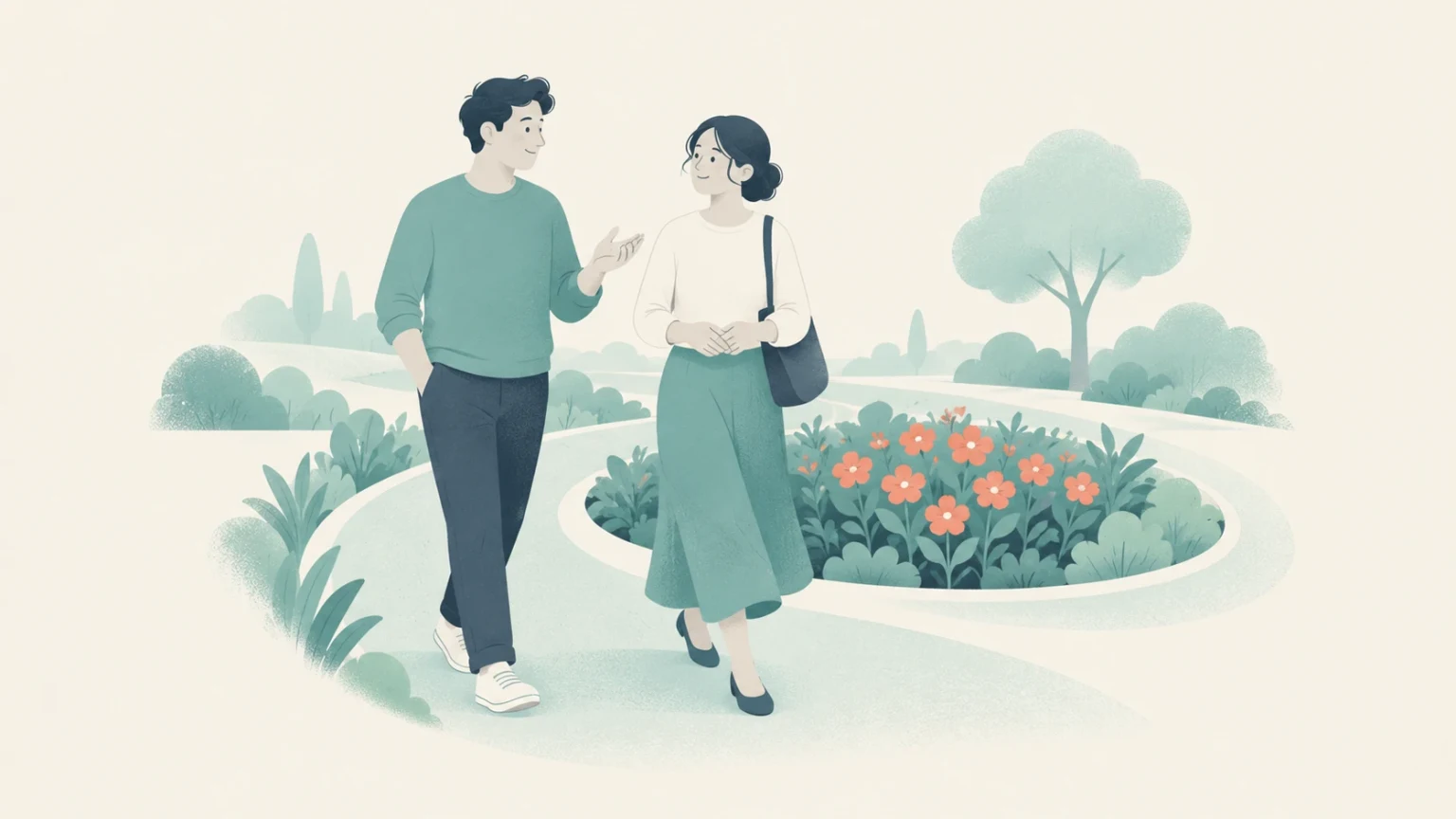 A man and a woman talking while walking along a curving path around a circular bed of orange flowers.