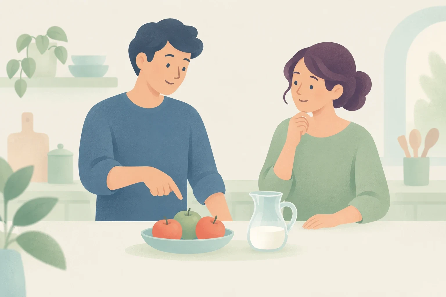 A man points to a few apples in a bowl next to a pitcher with a little milk on a kitchen counter beside a woman.