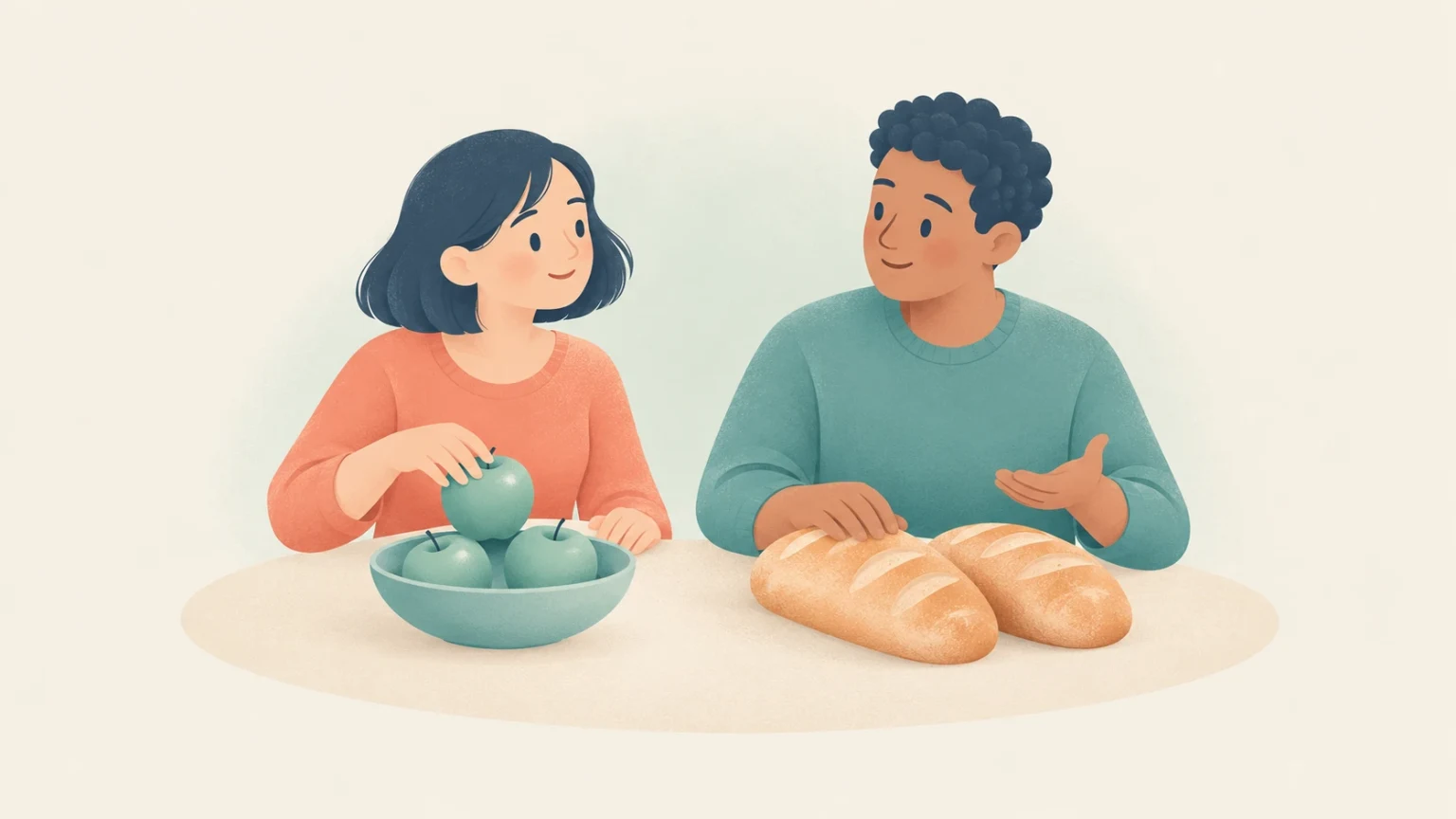A woman reaches for an apple in a bowl while a man gestures beside two loaves of bread on a table.