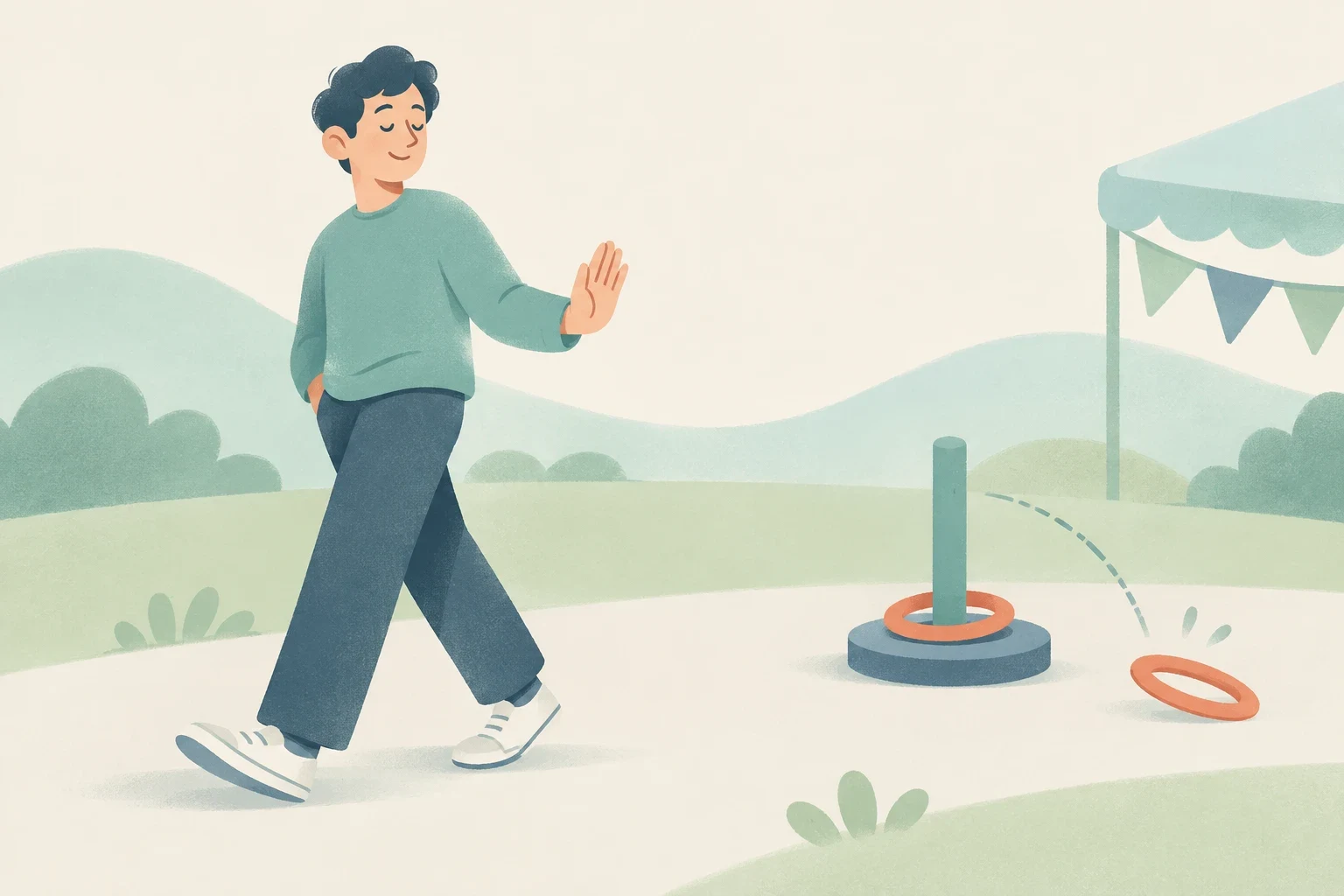 A young man walks past a ring toss game at an outdoor fair, smiling and raising a hand to politely decline playing.