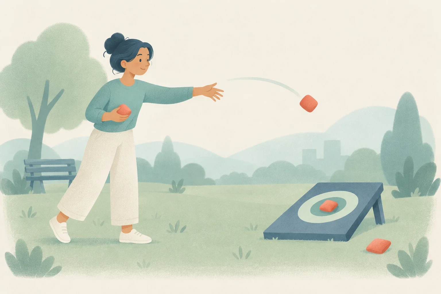 A woman plays beanbag toss in a park, aiming at a target board where one bag hits the bullseye and another misses on the grass.